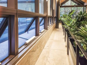 Chain actuators installed along a row of automated windows, with no visible surface cabling
